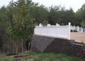 retaining wall with white fence